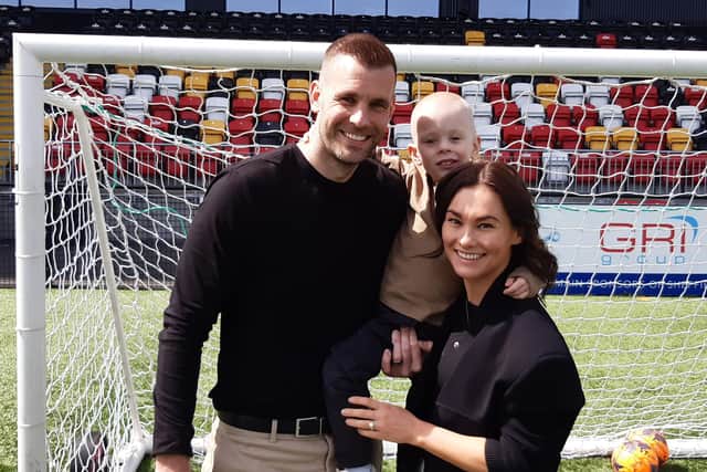 Fighting back: Tommy Spurr, left, with his wife Chloe and their son Rio, 4, who was diagnosed with Wilms' tumour last April but last week was given some good news at last. Spurr is hosting a Steel City derby to raise money for his son.