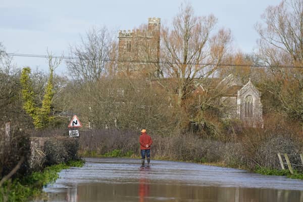 A man looks at floodwater in Hampshire earlier this year. PIC: Andrew Matthews/PA Wire