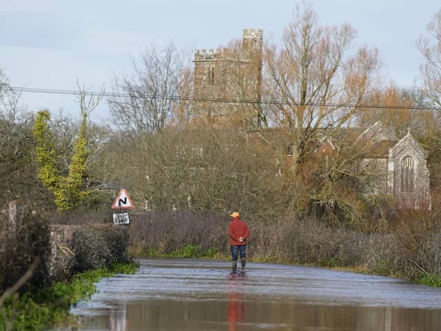 A man looks at floodwater in Hampshire earlier this year. PIC: Andrew Matthews/PA Wire