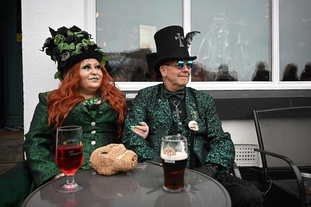 A couple stop for a drink during Whitby Goth Weekend