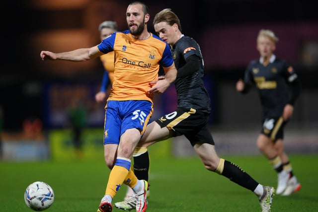 John-Joe O'Toole of Mansfield Town is tackled by Lucas De Bolle of Newcastle United during the Papa John's EFL Trophy Group match between Stags and Newcastle United U21s on November 09, 2021.