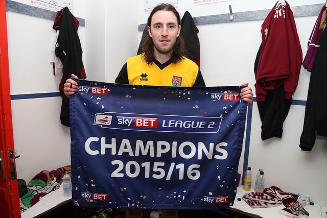 John-Joe O'Toole of Northampton Town celebrates after after his team had been crowned champions of League Two after the Sky Bet League Two match between Exeter City and Northampton Town at St James Park on April 16, 2016.