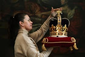 A replica set of the Crown Jewels, on display a t Newby Hall, near Ripon. Picturedv isitor services manager Sarah Barlow with St Edward's Crown.
Photographed by  Jonathan Gawthorpe.