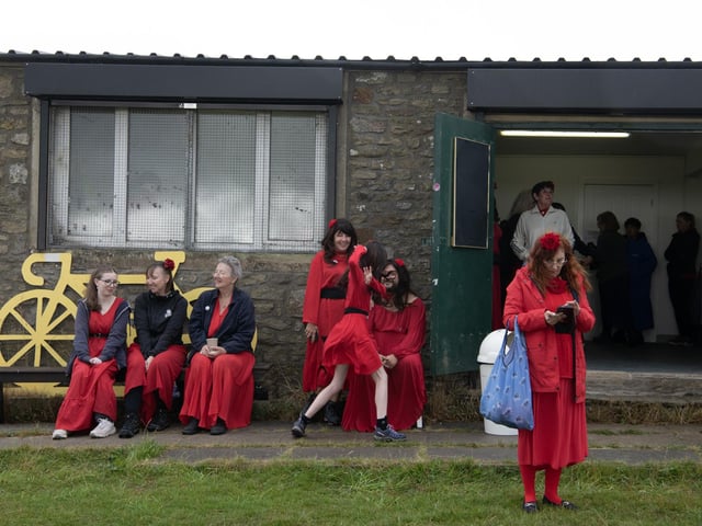 Participants gather at Penistone Country Park in Haworth for Actually the Most Wuthering Heights Day Ever - a celebration of all things Wuthering Heights, Kate Bush and Emily Brontë in the stunning setting of the Haworth moors.  500 people took part in the mass 'Wuther' in a joyful, windswept, red-dress sea of Cathys dancing for charity, supporting  Women’s Aid Picture by Tony Johnson.  24th July 2026