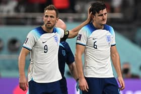 England's forward #09 Harry Kane (L) gestures to his teammate defender #06 Harry Maguire during the Qatar 2022 World Cup Group B football match between England and Iran at the Khalifa International Stadium in Doha on November 21, 2022. (Photo by PAUL ELLIS/AFP via Getty Images)