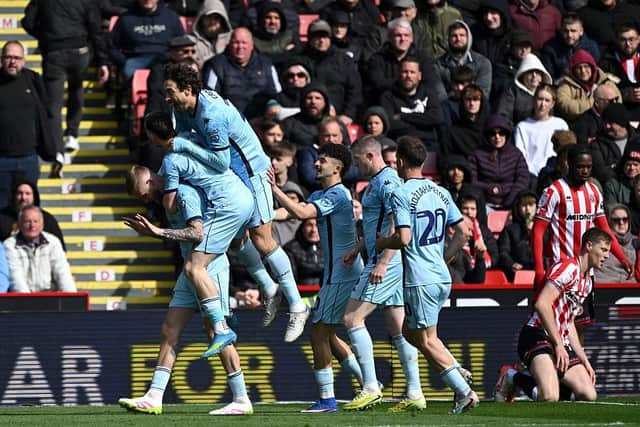 PILE ON: Hull City celebrate after Oli McBurnie opens the scoring at Sheffield United (Image: Mark Sutton/Getty Images)