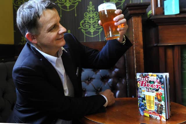 Simon Jenkins checking out a pint  at The Fenton on Woodhouse Lane in Leeds, with the 2019 version of The Yorkishire Beer Bible. Picture: Gary Longbottom.