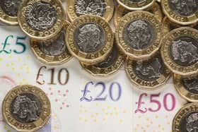 What is the National Living Wage and what is the minimum hourly rate of pay currently in the UK in 2022?