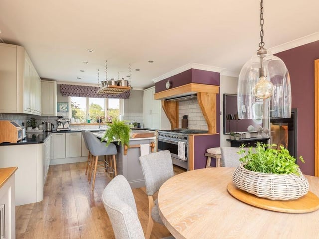 Integrated appliances in the kitchen dining room include a range cooker, dishwasher, fridge freezer and wine cooler.