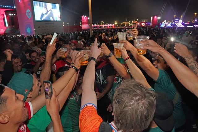 Mexican and Dutch fans enjoy a beer at the FIFA Fan Festival in Al Bidda Park in Doha, Qatar during the FIFA World Cup 2022. (Photo credit: Jonathan Brady/PA Wire)