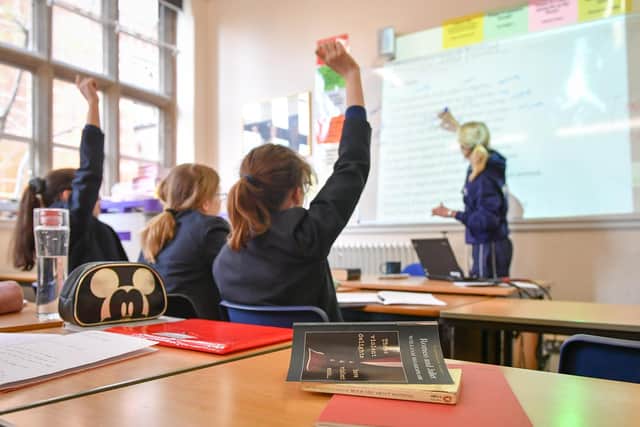 A teacher and students in a classroom. The teaching profession is facing spiralling workloads. PIC: Ben Birchall/PA Wire
