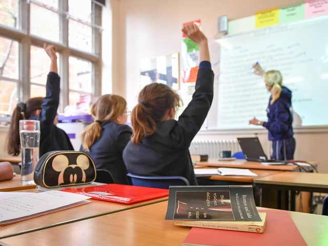 A teacher and students in a classroom. The teaching profession is facing spiralling workloads. PIC: Ben Birchall/PA Wire