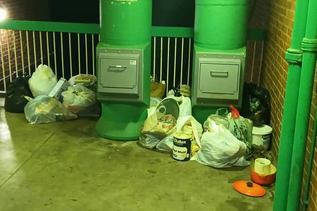 Rubbish piled up on a housing estate where a city council has locked away wheelie bins and told residents to use bin chutes - which are too small