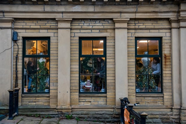 One of the first window display's to go live designed by Level 3, City and Guilds, Floristry students from Shipley College in the three windows at Mill Building , Victoria Road, Saltaire, Bradford. Pictured (left to right) Katie Robertson, Izzy Spilsbury, and Jess Darkens.