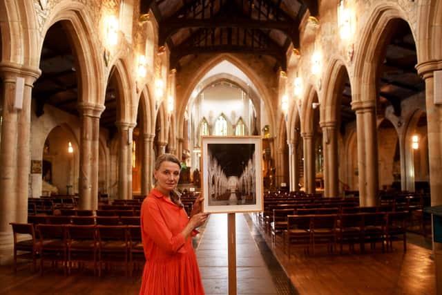 Exhibition of photographs by photographer Peter Marlow called the The English Cathedral at Bradford Cathedral. Fiona Naylor is pictured with an Image of Bradford Cathedral taken by Peter