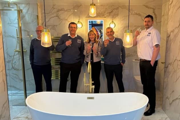 Sandra Marchington (centre) and her husband Paul, second from left, celebrate the completion of the showrooms with staff Mark Radley, Paul Warris and Will Green.