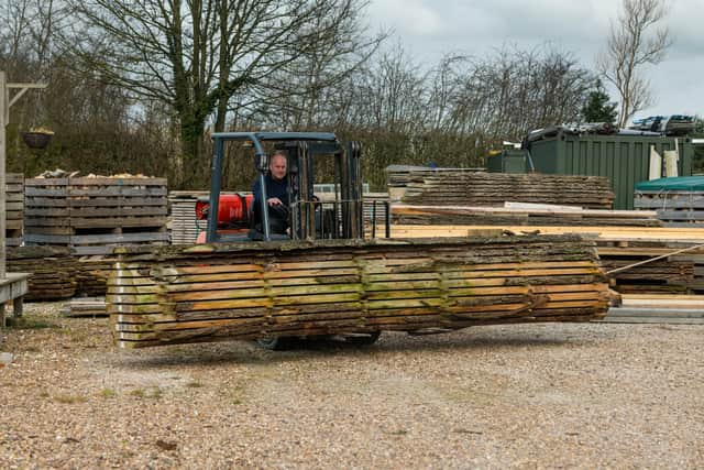 Joe Vaudin, moving timber in their yard.
Picture By Yorkshire Post Photographer,  James Hardisty.