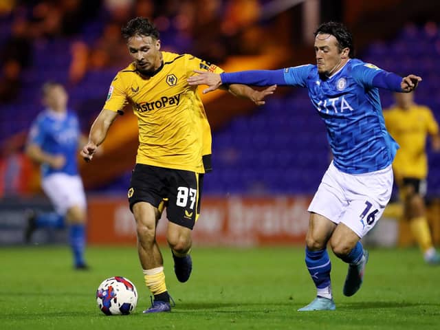 STOCKPORT, ENGLAND - SEPTEMBER 20: Tyler Roberts of Wolverhampton Wanderers is challenged by James Brown of Stockport County during the Papa John's Trophy match between Stockport County and Wolverhampton Wanderers U21 at Edgeley Park on September 20, 2022 in Stockport, England. (Photo by Charlotte Tattersall/Getty Images)