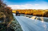 A farmer drives a tractor along the lightly snow covered road. PIC: James Hardisty