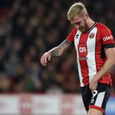 SUFFERING: Oli McBurnie fights the discomfort during Sheffield United's 2-1 defeat to Manchester United