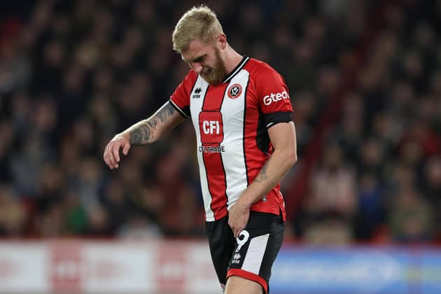 SUFFERING: Oli McBurnie fights the discomfort during Sheffield United's 2-1 defeat to Manchester United