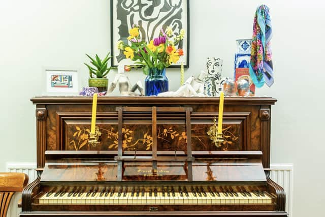 The piano now has a new home in Amy's house. On top is some of her work
