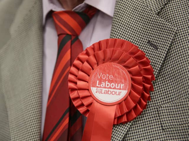 A file photo of a man wearing a Labour rosette. PIC: Daniel Leal-Olivas/PA Wire