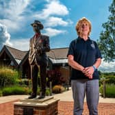 Centre manager Jo Russell, next to a bronze statue of horse trainer Jack Berry which the centre is named after.