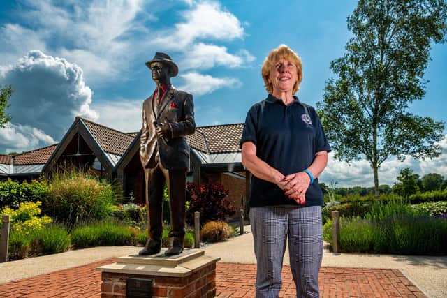 Centre manager Jo Russell, next to a bronze statue of horse trainer Jack Berry which the centre is named after.