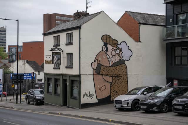 Sheffield artist Pete McKee by his famous mural The Snog on the gable end of Fagans pub in the city, which is the subject of a new exhibition, photographed for the Yorkshire Post Magazine by Tony Johnson.