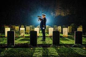 Handout photo taken by Tony Johnson from the Yorkshire Post of SLt (SCC) Dan Wilding RNR playing the last post at the Candlelit Christmas Remembrance event held at the Commonwealth War Graves Commission's Stonefall Cemetery in Harrogate, which has been shortlisted in the Genesis Imaging Regional Photographer of the Year  category at the UK Picture Editors Guild Awards 2023. Tony Johnson/PA Wire.