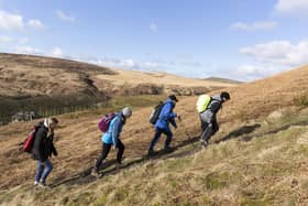 Hiking group on a guided hike led by rangers at Marsden Moor, West Yorkshire