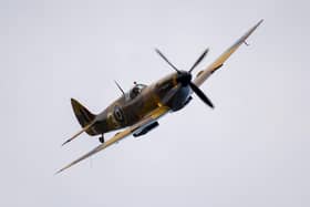 A Spitfire makes a fly past as The Secret Spitfires Memorial is unveiled. (Pic credit: Finnbarr Webster / Getty Images)