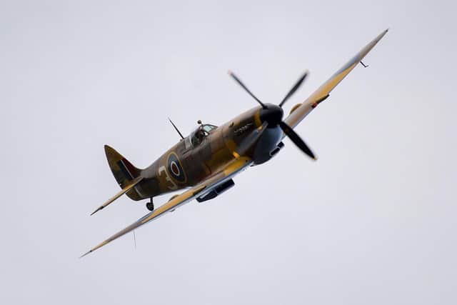 A Spitfire makes a fly past as The Secret Spitfires Memorial is unveiled. (Pic credit: Finnbarr Webster / Getty Images)