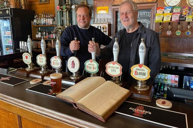 Jamie Allsopp and Steve Holt with the Allsop's ledger
