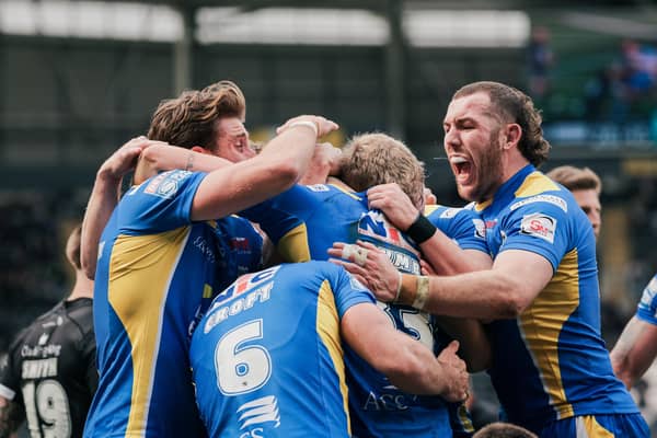 Riley Lumb is mobbed after scoring his first Super League try. (Photo: Alex Whitehead/SWpix.com)