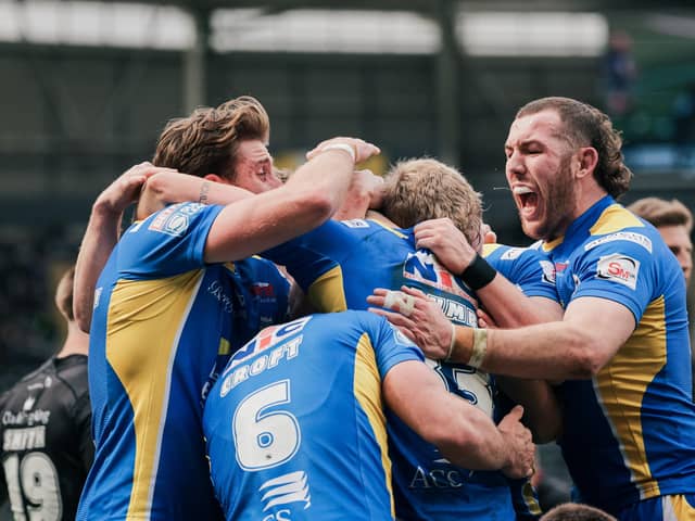 Riley Lumb is mobbed after scoring his first Super League try. (Photo: Alex Whitehead/SWpix.com)