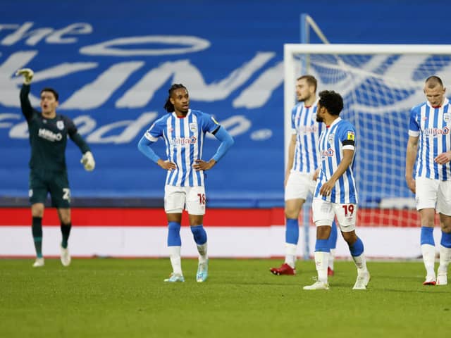 Huddersfield Town players show their dejection after conceding a late goal during the Sky Bet Championship match at the John Smith's Stadium, Huddersfield. Picture: Richard Sellers/PA