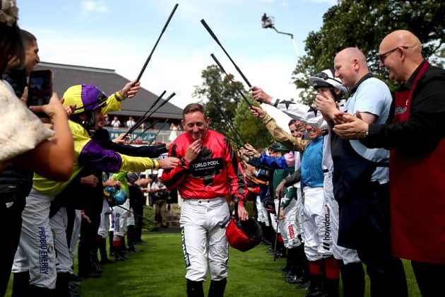 FAREWELL: Jockey Paul Hanagan receives a guard of honour in the parade ring before he rides in the Sky Bet Handicap, his last race before retirement, on day three of the Sky Bet Ebor Festival at York Racecourse. Picture: Simon Marper/PA