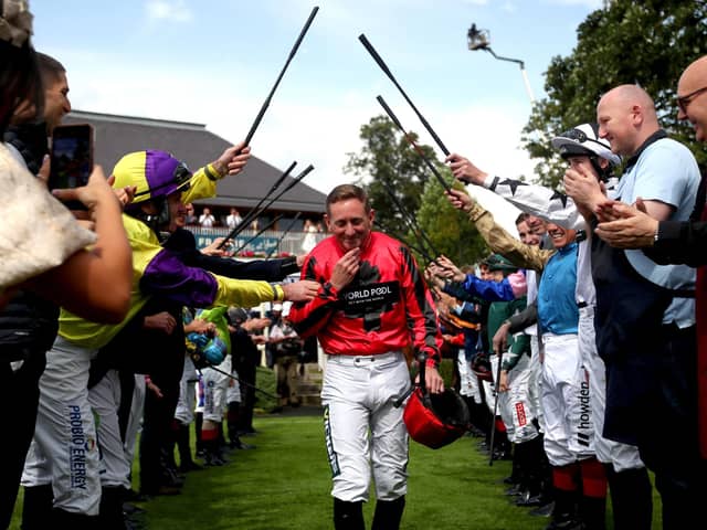 FAREWELL: Jockey Paul Hanagan receives a guard of honour in the parade ring before he rides in the Sky Bet Handicap, his last race before retirement, on day three of the Sky Bet Ebor Festival at York Racecourse. Picture: Simon Marper/PA