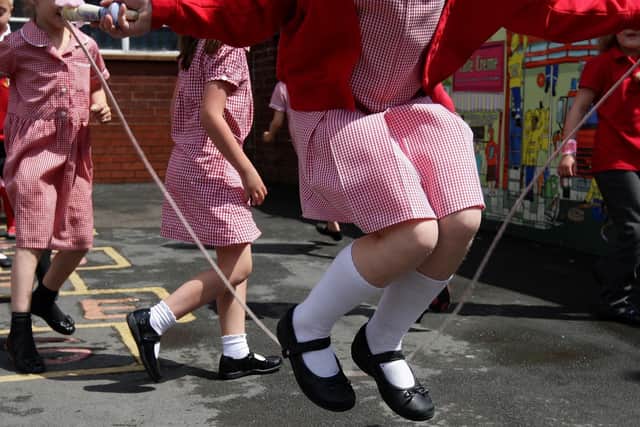 Children skip and play hop scotch during playtime. Image: PA