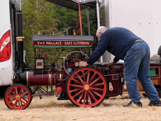 A miniature steam engine receives some final adjustments ahead of another day at the Masham Steam Engine and Fair Organ Rally