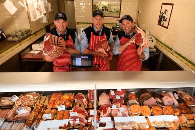Matt Slack  (centre) pictured with his brothers Luke (left) and Tom in the butchers shop
