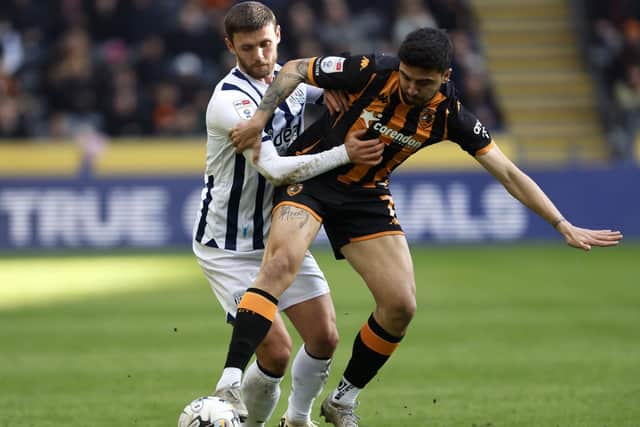 GETTING TO GRIPS: West Bromwich Albion's John Swift (left) tries to win the ball off Hull City substitute Ozan Tufan