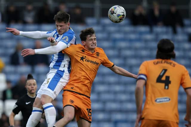 AERIAL DUEL: Huddersfield Town's Ben Wiles competes with the ball with Tyler Morton