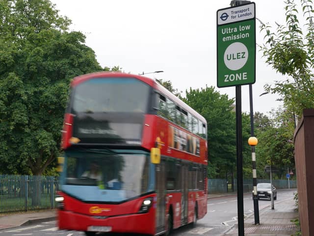 A London bus passes an information sign for the Ultra Low Emission Zone (Ulez) in London. PIC: Lucy North/PA Wire