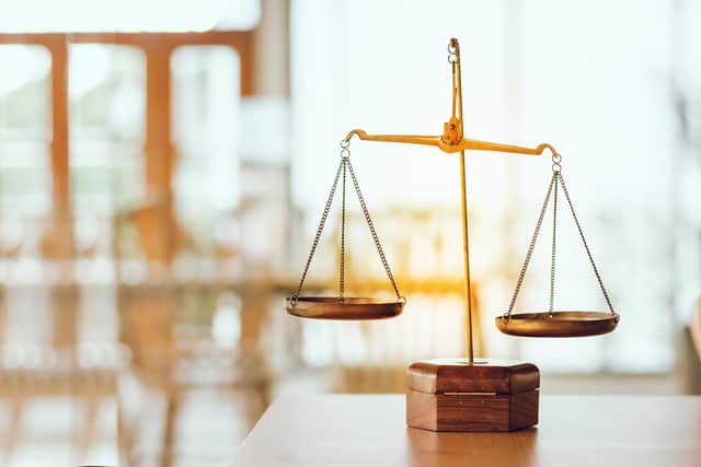 Scales of justice on a table. PIC: Adobe