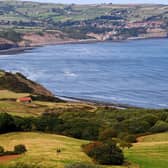 The view from Ravenscar looking towards Robin Hoods Bay. A couple of walkers are pictured in the distance heading towards the Cleveland Way. Picture taken by Yorkshire Post Photographer Simon Hulme