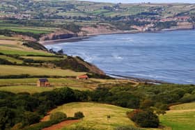 The view from Ravenscar looking towards Robin Hoods Bay. A couple of walkers are pictured in the distance heading towards the Cleveland Way. Picture taken by Yorkshire Post Photographer Simon Hulme