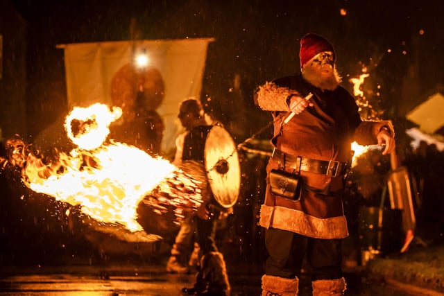 A performer swings a fireball during the Flamborough Fire Festival, a Viking themed parade in aid of charities and local community groups, held on New Year's Eve in Flamborough near Bridlington, Yorkshire. Picture date: Saturday December 31, 2022.